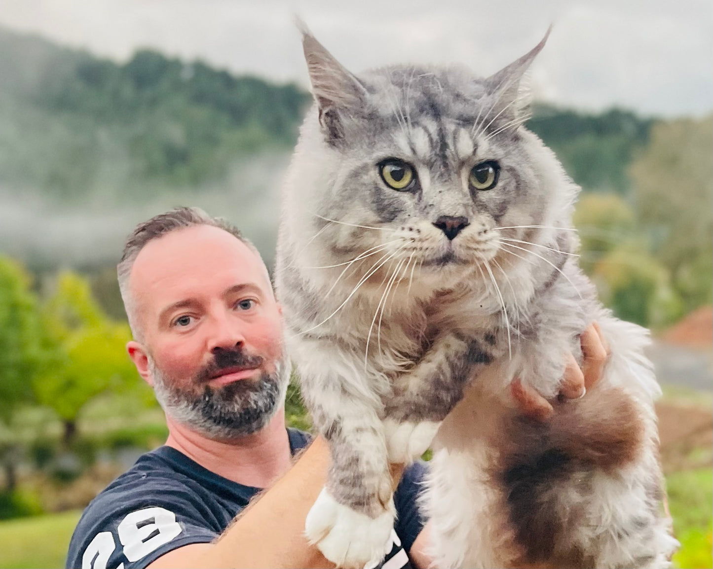 Petr holding our breeding stud maine coon
